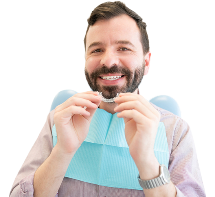 A Middle Aged Man With Dark Hair Holding Clear Aligners