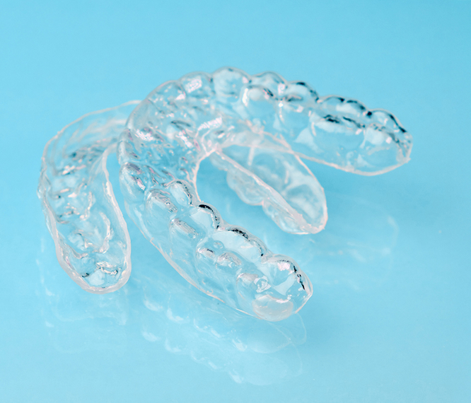 Clear Aligners On A Blue Table