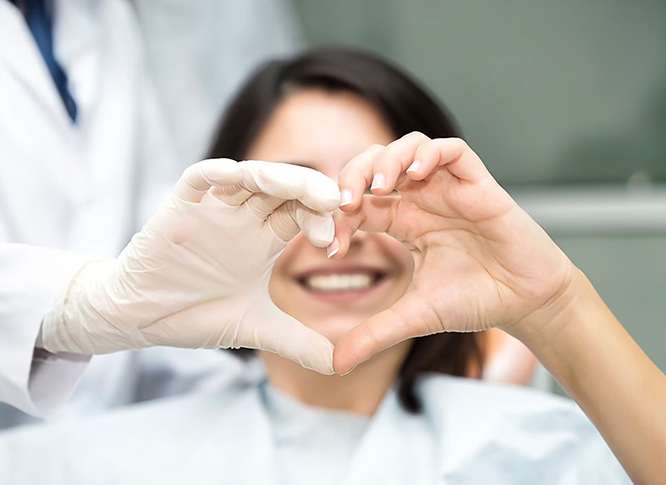 The Doctor And Patient Forming A Heart With Their Hands