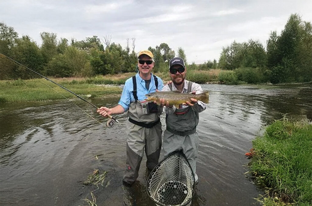 Dr Lang At A Lake Fishing With His Family