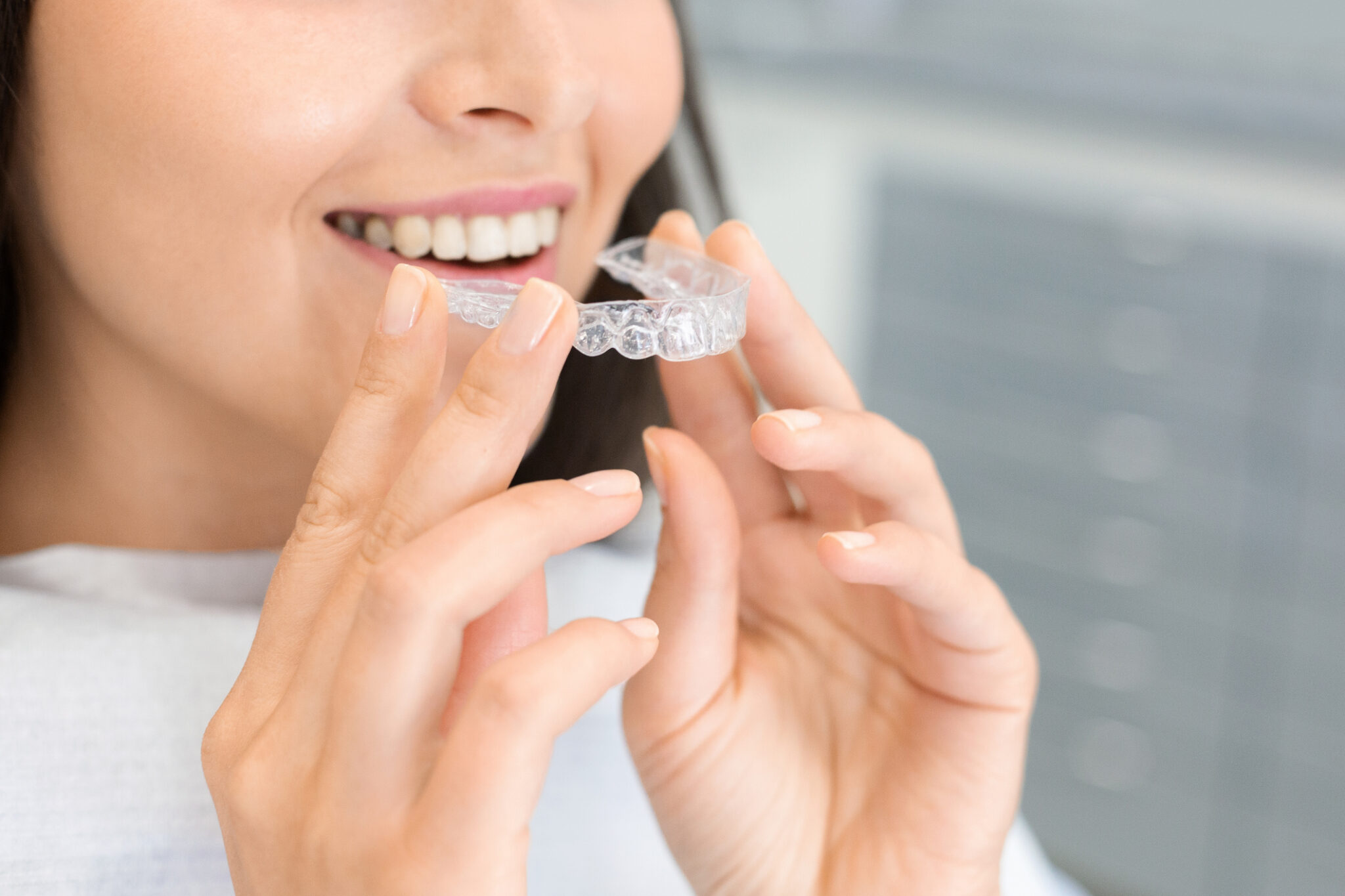 Young woman holding clear retainer