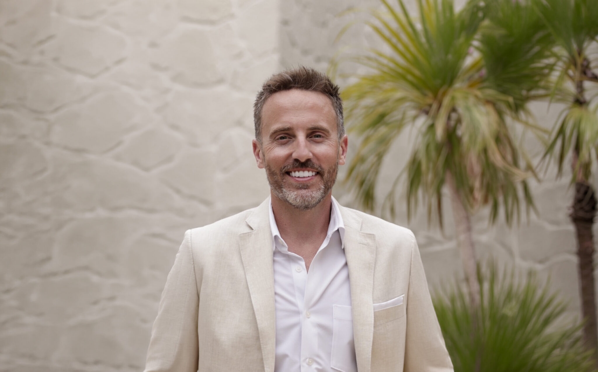 A Portrait Of Dr Adam Rudmann In A White Suit