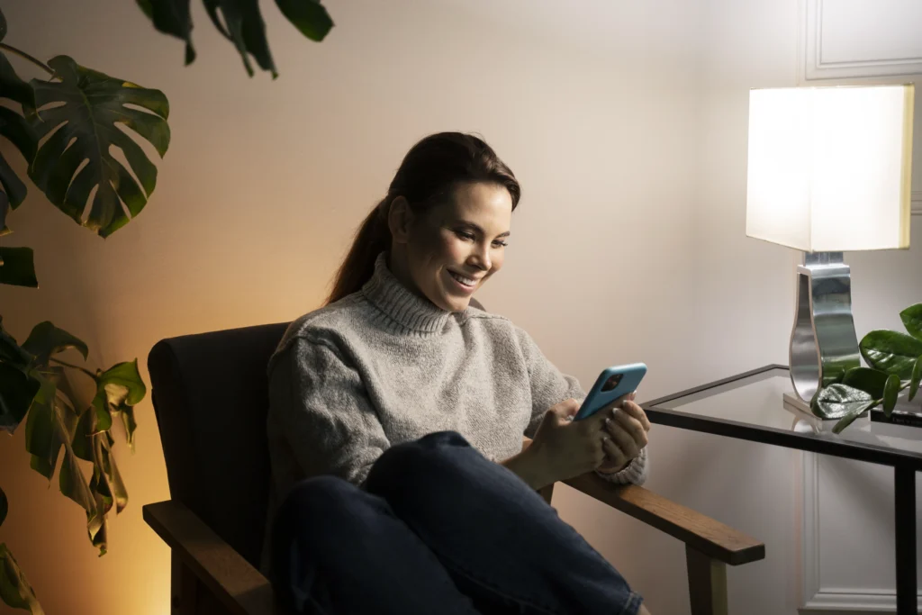 Woman using smartphone in comfortable setting