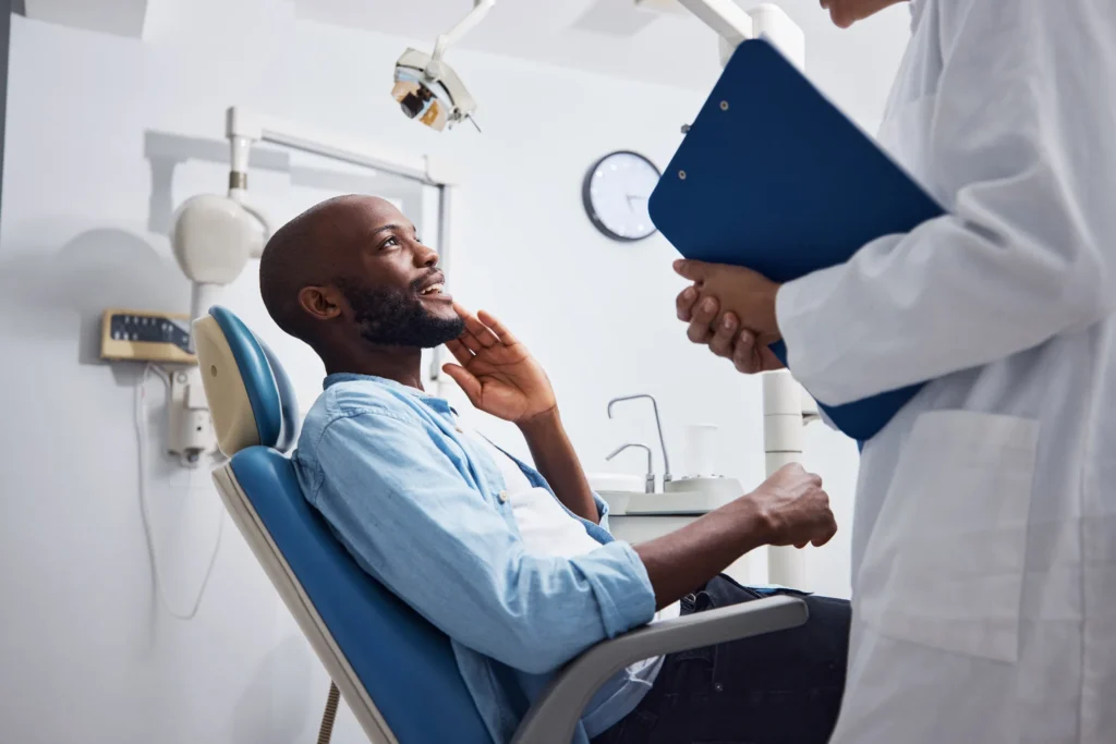 Man At The Dentist Consulting With Doctor