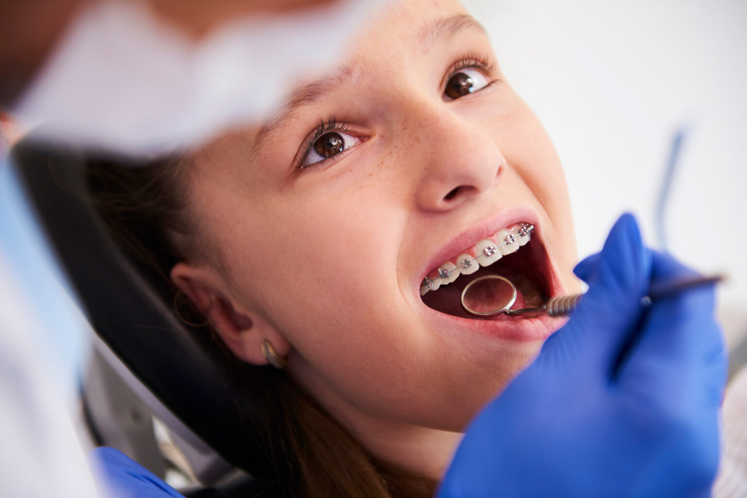 Girl With Braces Routine Dental Examination