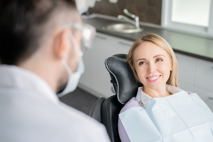 Woman Sminling In A Dentist Chair